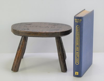 Lot 280 - An antique oak stool carved Rutland to the top,...