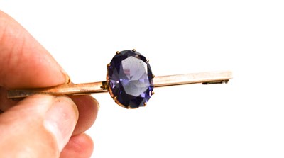 Lot 30 - A rose gold (untested) and amethyst set brooch...