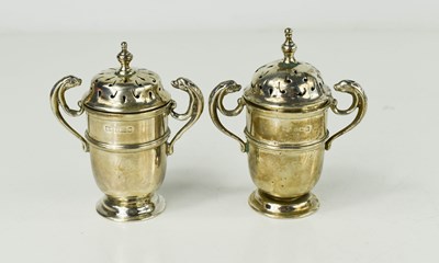 Lot 11 - A silver salt and pepper, in the form of urns...