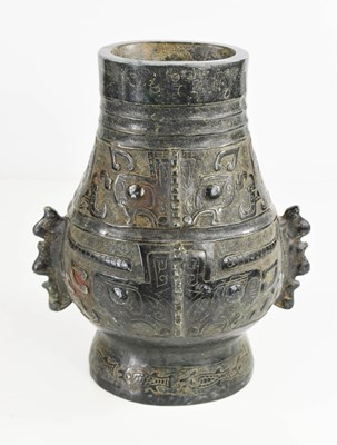 Lot 19 - A Chinese dark green jade carved vase, with...