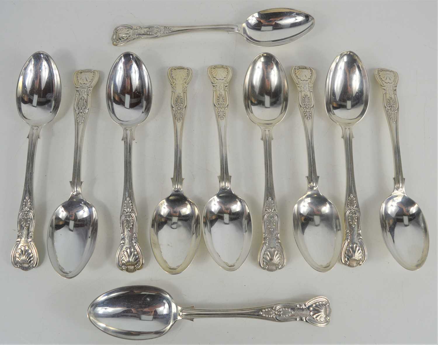 Lot 324 Eleven silver dessert spoons in the Kings