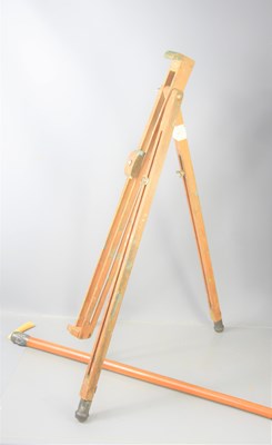 Lot 185 - A pine floor standing artist's easel together...