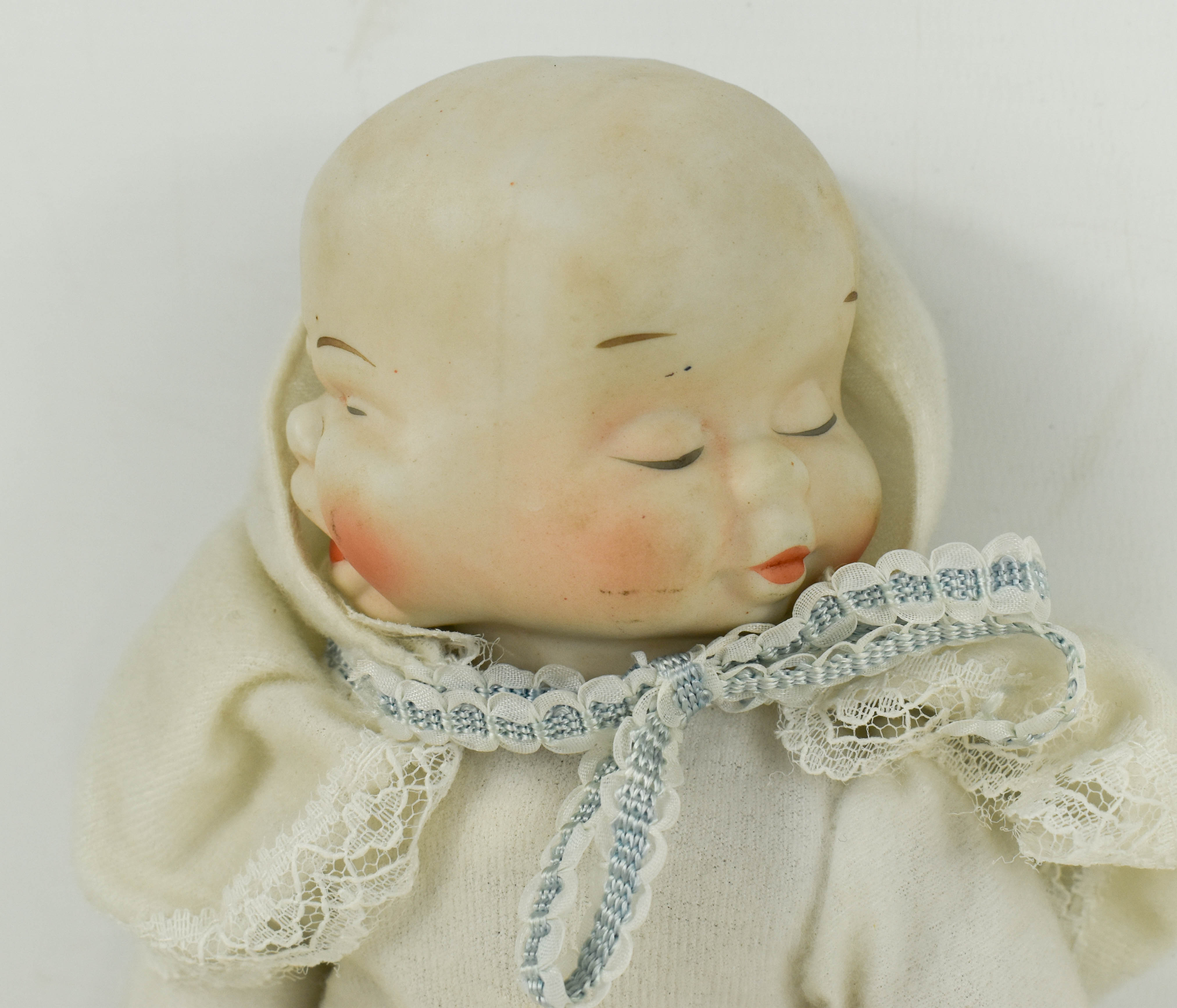 Three store faced doll