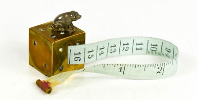Lot 117A - An antique brass and silver novelty tape...