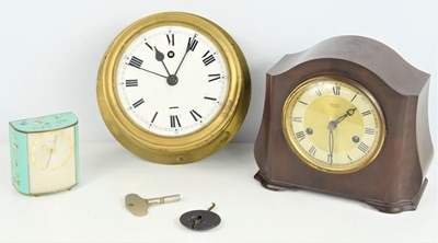 Lot 57 - A brass circular bulkhead clock, a Bakelite...