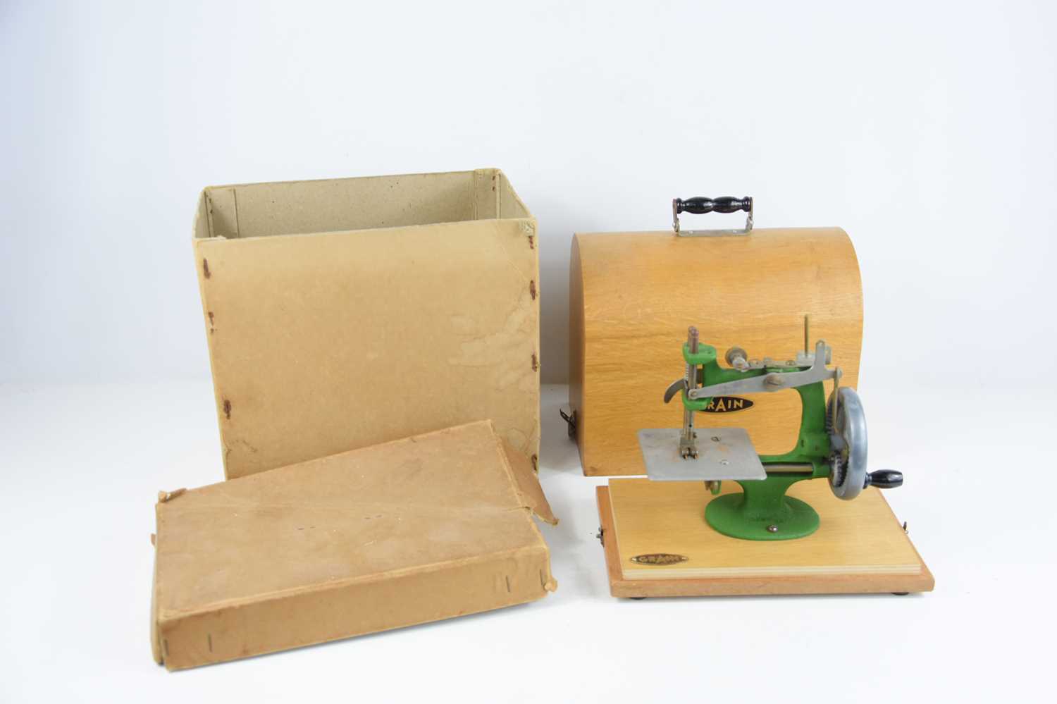 Lot 322 - A vintage Grain toy sewing machine, boxed.