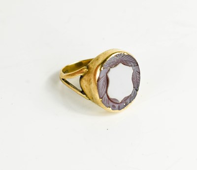 Lot 143 - A 9ct gold and agate inset ring carved with a...