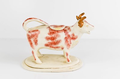 Lot 518 - An early 20th century cow creamer with...