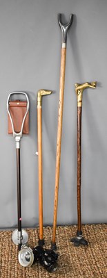 Lot 147 - A vintage shooting stick, crook, and two brass...
