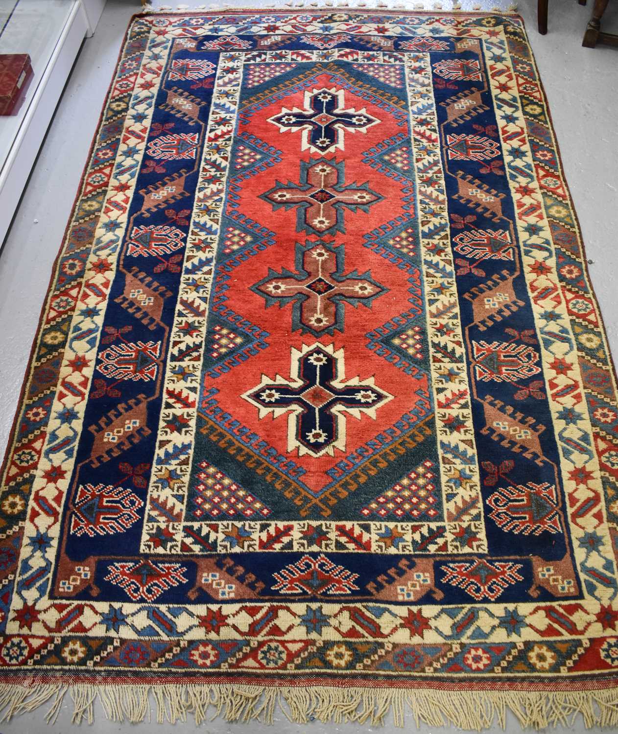 Lot 431 - A Middle Eastern wool rug, with four stylised...