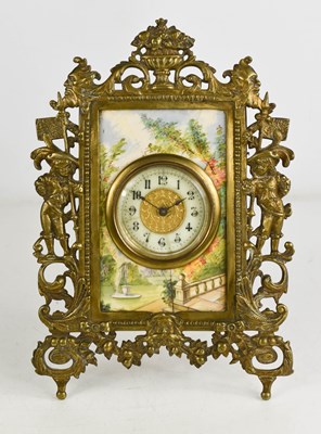 Lot 18 - A French brass and porcelain table clock, the...
