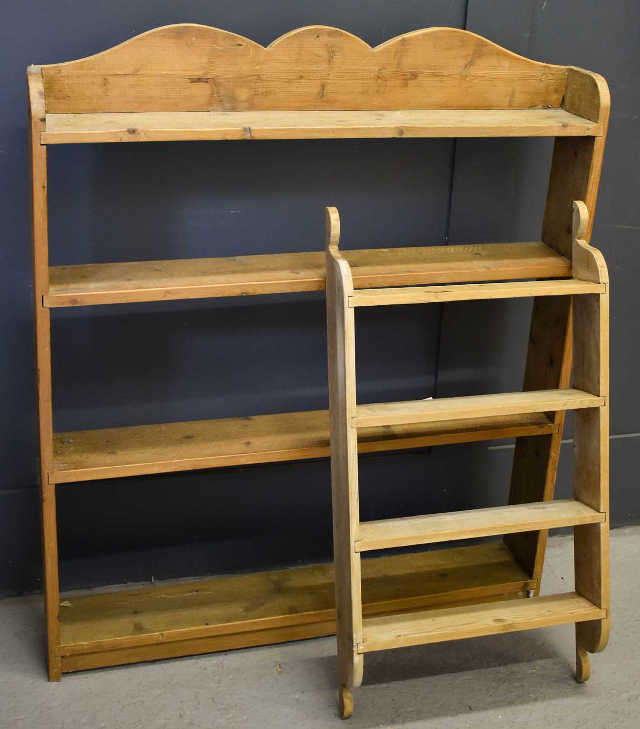 Lot 484 - An antique pine wall shelf with shaped top,...