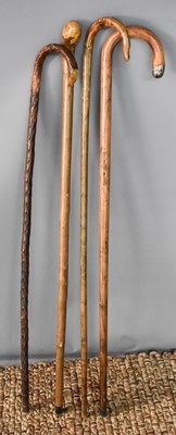 Lot 177 - A group of four walking canes of various form.