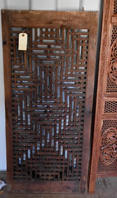Lot 489 - A bi-fold Indonesian hardwood carved screen,...