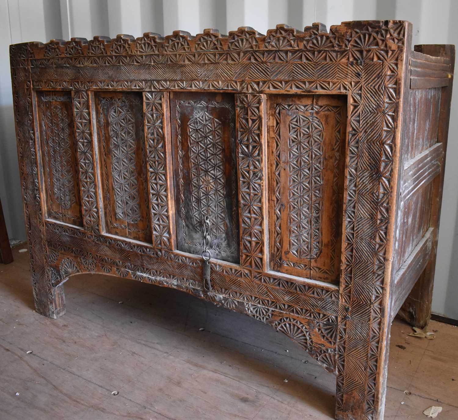 Lot 505 - A 19th century carved chest, the planked top...