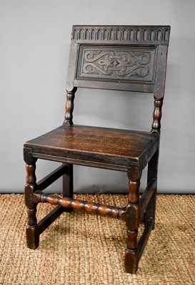 Lot 523 - An 18th century oak chair, the back panel...