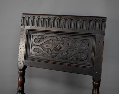 Lot 523 - An 18th century oak chair, the back panel...