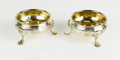 Lot 130 - A pair of silver salts, raised on three feet,...