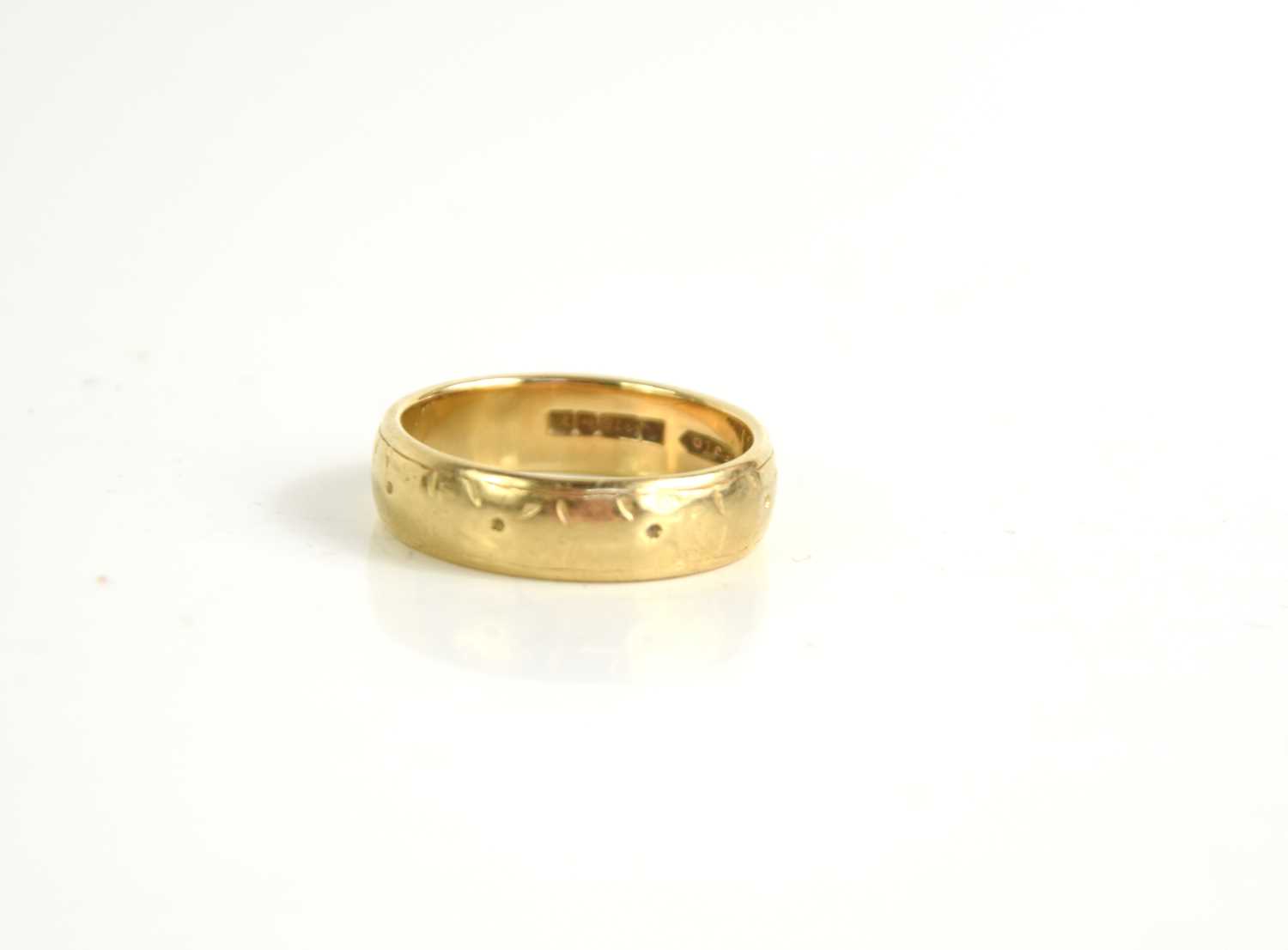Lot 94 - A 9ct gold wedding band, with engraved detail,...
