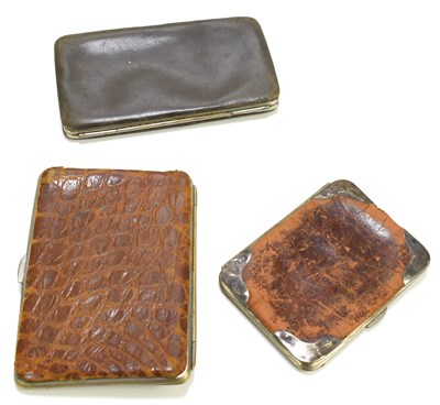 Lot 556 - A crocodile skin and silver cigarette case and...