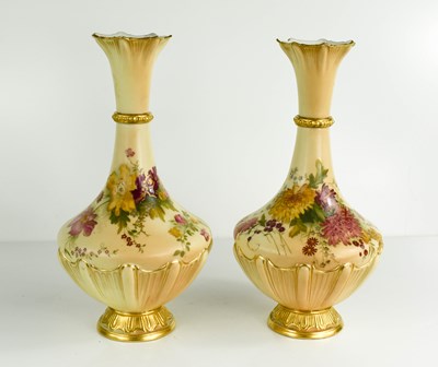 Lot 488 - A pair of peach ground vases, painted...