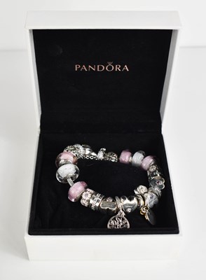 Lot 152 - A silver Pandora charm bracelet, with nineteen...