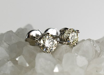 Lot 137 - A pair of diamond solitaire earrings, set in...