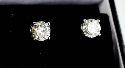 Lot 137 - A pair of diamond solitaire earrings, set in...