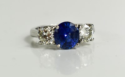 Lot 161 - A platinum, blue sapphire and diamond three...