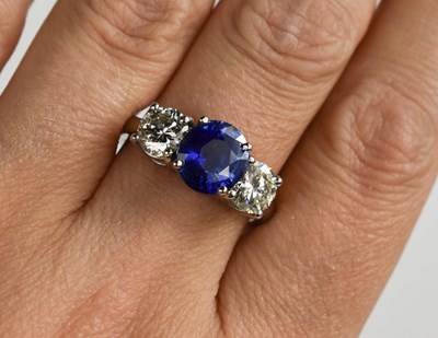 Lot 161 - A platinum, blue sapphire and diamond three...