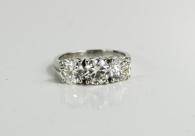 Lot 181 - A platinum and diamond trilogy ring, each...