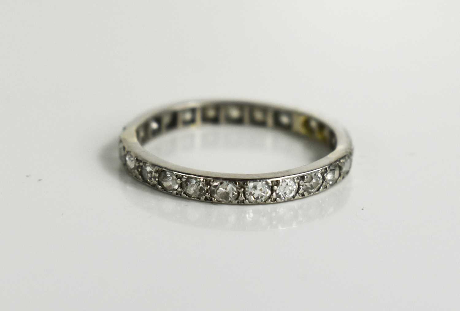 Lot 108 - An Art Deco platinum and diamond eternity ring,...