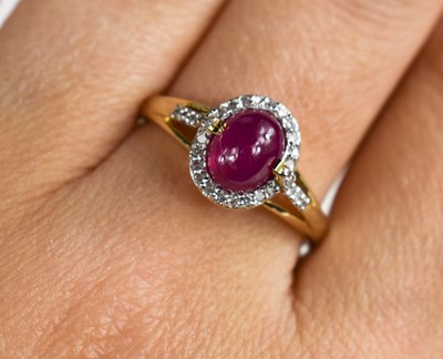 Lot 140 - A 9ct gold cabochon ruby and diamond ring,...