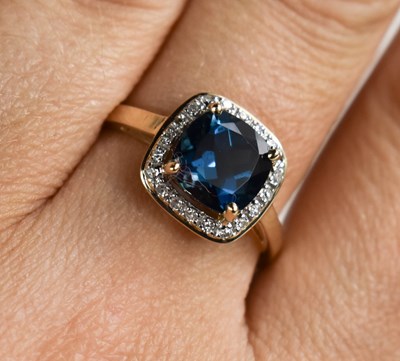 Lot 133 - A 9ct gold and blue topaz and diamond ring,...