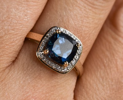 Lot 133 - A 9ct gold and blue topaz and diamond ring,...