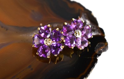 Lot 104 - A 9ct gold and amethyst flowerhead stud...