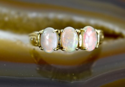 Lot 132 - A 9ct gold oval opal trilogy ring, size R, 3g.
