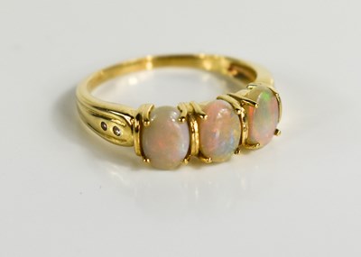 Lot 132 - A 9ct gold oval opal trilogy ring, size R, 3g.