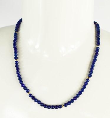 Lot 22 - A 9ct gold and lapiz lazuli beaded necklace,...