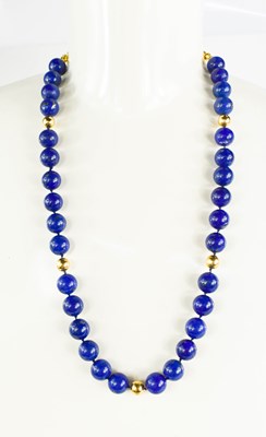 Lot 27 - An 18ct gold and lapiz lazuli beaded necklace,...