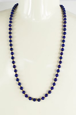 Lot 21 - A 9ct gold and lapiz lazuli beaded necklace...