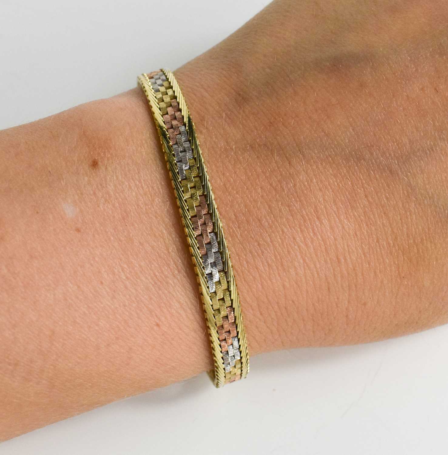 Lot 102 - A 9ct rose, yellow and white gold bracelet,...