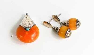 Lot 303 - An amber, tuquoise and silver pendant,...