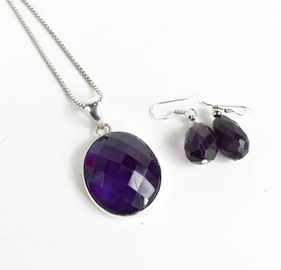 Lot 279 - An amethyst oval pendant set in silver, with...