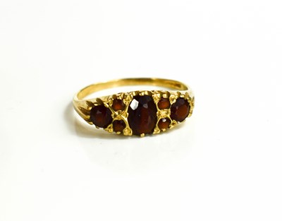 Lot 52 - A vintage 9ct gold and garnet set ring, Size U,...