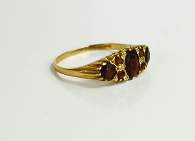 Lot 52 - A vintage 9ct gold and garnet set ring, Size U,...