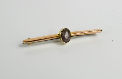 Lot 54 - A 9ct gold and amethyst bar brooch, with steel...