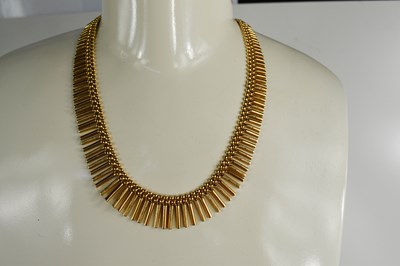 Lot 176 - An 18ct gold Egyptian style articulated fringe...