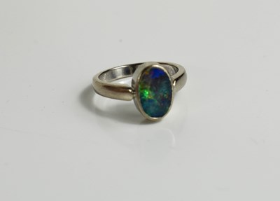 Lot 134 - An 18ct white gold and black opal ring, the...
