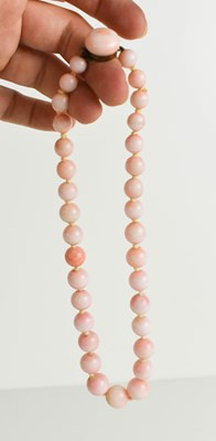 Lot 56 - A pink stone beaded necklace, likely angel...